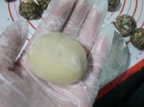 提前洗好50克月饼模具，把圆球搓成椭圆状放入模具中。