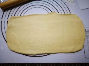 拿一个面团用擀面仗擀成长方形，上面那边稍微薄一点