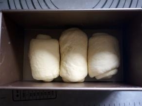 将面团擀开，然后卷起，排放入吐司盒中。