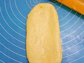 将包入椰蓉馅的面团擀成长圆形