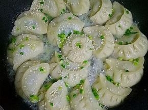 撒入白芝麻（黑芝麻也可以），小葱碎，盖上锅盖焖至水干即可