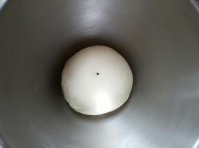 5．取出面团，在面板上进行摔打，揉圆成团醒发30分钟。