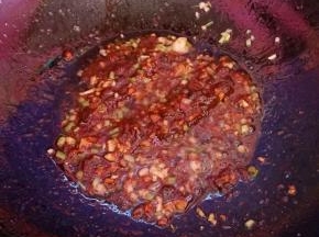 小豆瓣酱炒出红油，再烹入料酒。