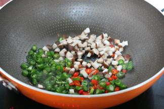 煎过豆腐的油锅放入辣椒、香菇小火煸香；