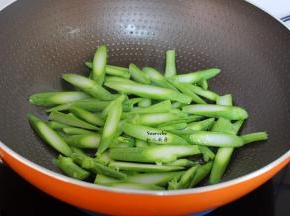 炒过腊肠的油锅，芥兰倒入锅中，爆炒片刻；