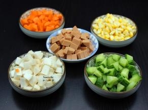 所有食材洗净，玉米掰成粒，杏鲍菇、火腿、胡萝卜、青瓜切成玉米大小粒；