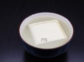 豆腐用盐水浸泡一下，捞出，切小方块；