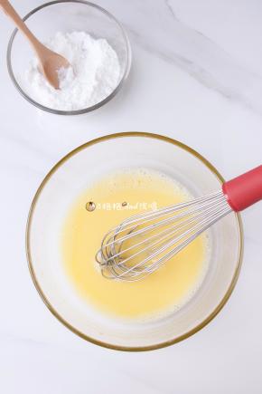 . 蛋黄加入细砂糖，搅拌至糖融化，分次加入玉米油和牛奶，拌匀