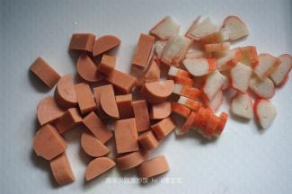 将火腿和蟹柳棒切丁。