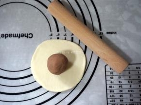 取其中一份，擀成圆形，包入馅料。