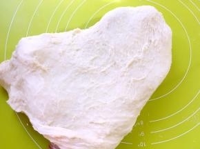 倒在揉面垫上，一直向前推揉至面团起筋，可以撑出厚厚的手套膜