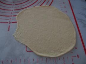 将面团擀成牛舌状，末端收口处压薄