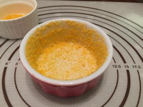 在碗中倒入面包糠，晃动整个舒芙蕾碗，让整个碗壁沾满，倒掉多余的面包糠