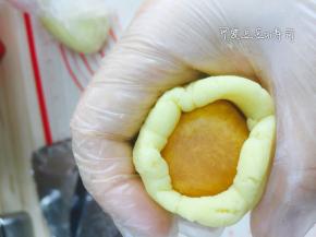 包入金丝肉松馅，用虎口慢慢往上推，包裹住月饼馅料