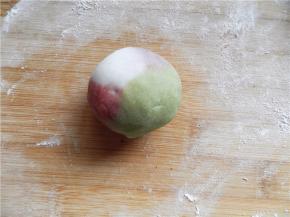 左手按馅的上端，右手虎口转边，将饼皮向上收口，揉圆。