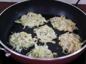 热锅，倒入油，把土豆丝用筷子放成薄薄的小圆饼，放入锅中煎；