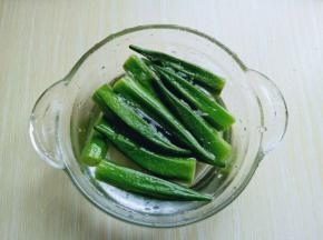 焯水的秋葵，捞出后立即过冷水。冷水泡一会。