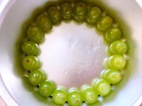 取绿色葡萄粒，平铺在6寸蛋糕模具外围一圈，葡萄粒的摆放要一致