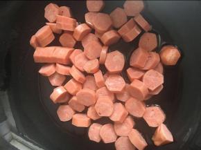 锅内倒入适量的植物油，加热后倒入切好的烤肠片中火翻炒2分钟