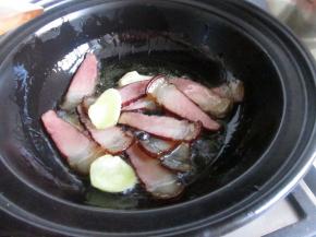 放入姜片和腊肉煸炒。