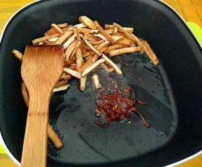 (推着一边或者是盛出)下干辣椒丝煸香。