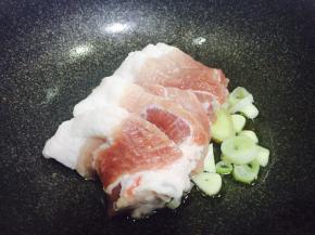 锅中倒油，油热下葱姜蒜翻炒出香味，然后下五花肉炒至变色