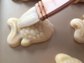 将月饼取出，待冷却一下，在表面刷上薄薄一层蛋黄水。继续烘烤15分钟