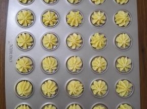 9、在模具上挤出大小均匀的花形，烤箱预热上火180度，下火160度，预热完成将模具放入烤箱，烤制12分钟，待饼干均匀上色后取出晾凉即可。