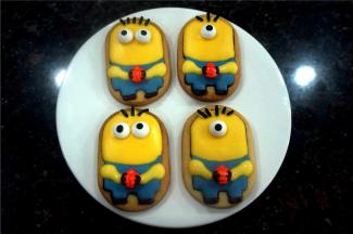 接着用黄色糖霜画上手臂，用巧克力在南瓜两边画上手指头，同时用巧克力画上鞋子