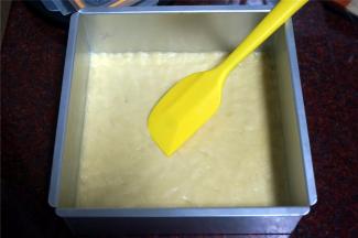 将面团平铺在方形模具里，用橡皮刮刀压平整或者手带手套后，用手推压平整。