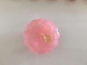 取一片月饼花片，如图为例。取少许牛奶桃山皮按花皮里的小花形状压好