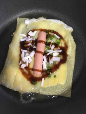 放上火腿肠，洋葱块，香菜碎，你还可以根据自己喜欢放点其他食材
