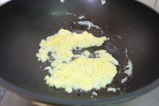 把鸡蛋打成蛋液，榨菜切碎；