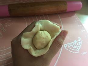 包入油酥，放在虎口处轻轻一推就可以包好