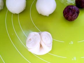 取一份松弛好的牛舌卷，从中间压一下，之后压扁，用擀面杖擀成圆片