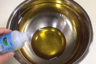 在盆内倒入转化糖浆和枧水，用手动打蛋器搅拌均匀。