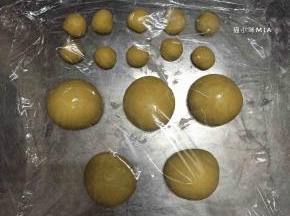 将发酵好的黄色面团排气，分出10份5克的面团，剩余的面团平均分为5份，揉圆并盖保鲜膜松弛10分钟