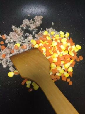 然后焯好的玉米粒和胡萝卜倒入翻炒