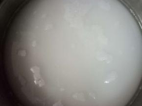 用一不锈钢煮锅，倒入水470克，再加入1000克的细砂糖，中火加热，用筷子不停的搅拌至糖全部溶化