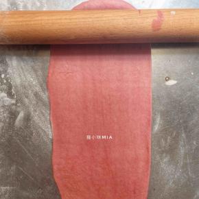 深红色的面团擀开，盖上保鲜膜松弛5分钟，再切成长条状