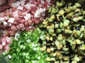 将猪肉丁，茄子丁，葱花放入一个大点的盆中。