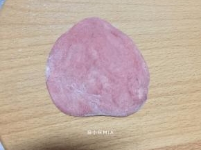 将红色面团的材料混合，揉成团后，用保鲜膜盖好，放旁备用