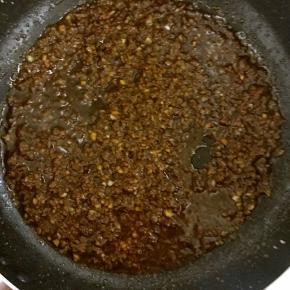 6. 待肉末变色后倒入调好的酱油汁，并加入适量水，翻炒片刻，关火