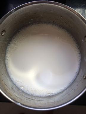 将牛奶倒入锅中，加热