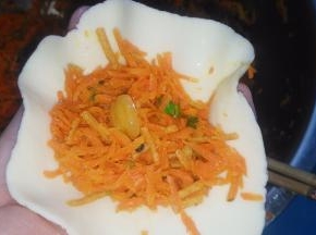 取一块面团，擀薄，包入馅儿。