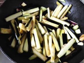8.	倒入茄条翻炒，让茄条均匀的沾到油，