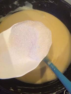 7、等到绿豆泥略干，加入白糖继续翻炒。