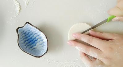 对折后，用刀子，如图，切出一个细长条。