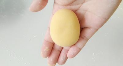 黄面团搓成，一头稍尖的椭圆体。