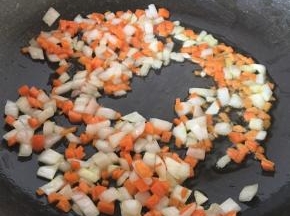 冷锅放半汤匙橄榄油，锅热后放入胡萝卜丁和洋葱丁翻炒出香味